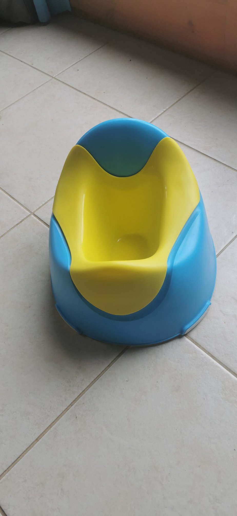 Blue and yellow child's potty available at Villa Koumos