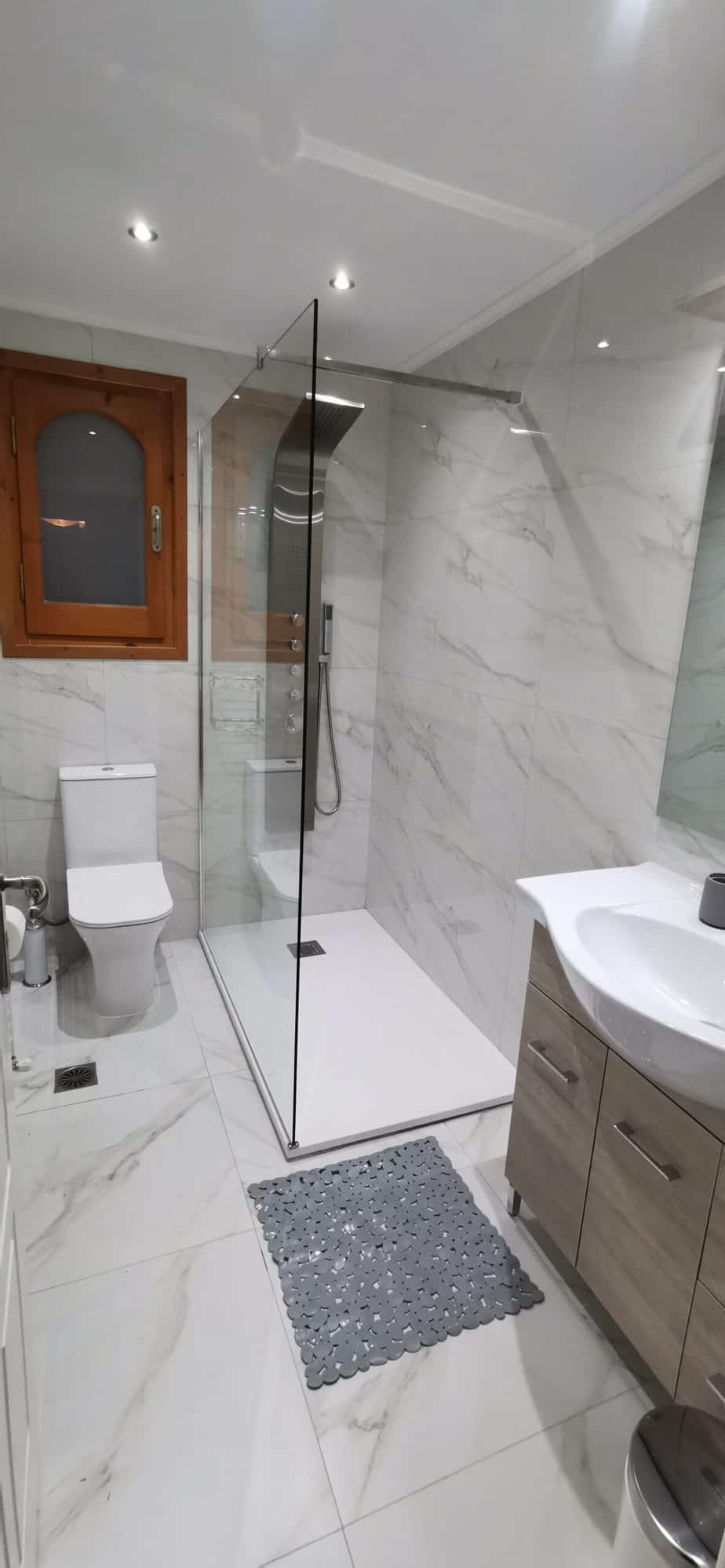 Master-bedroom en-suite wet room with shower, vanity and WC at Villa Koumos