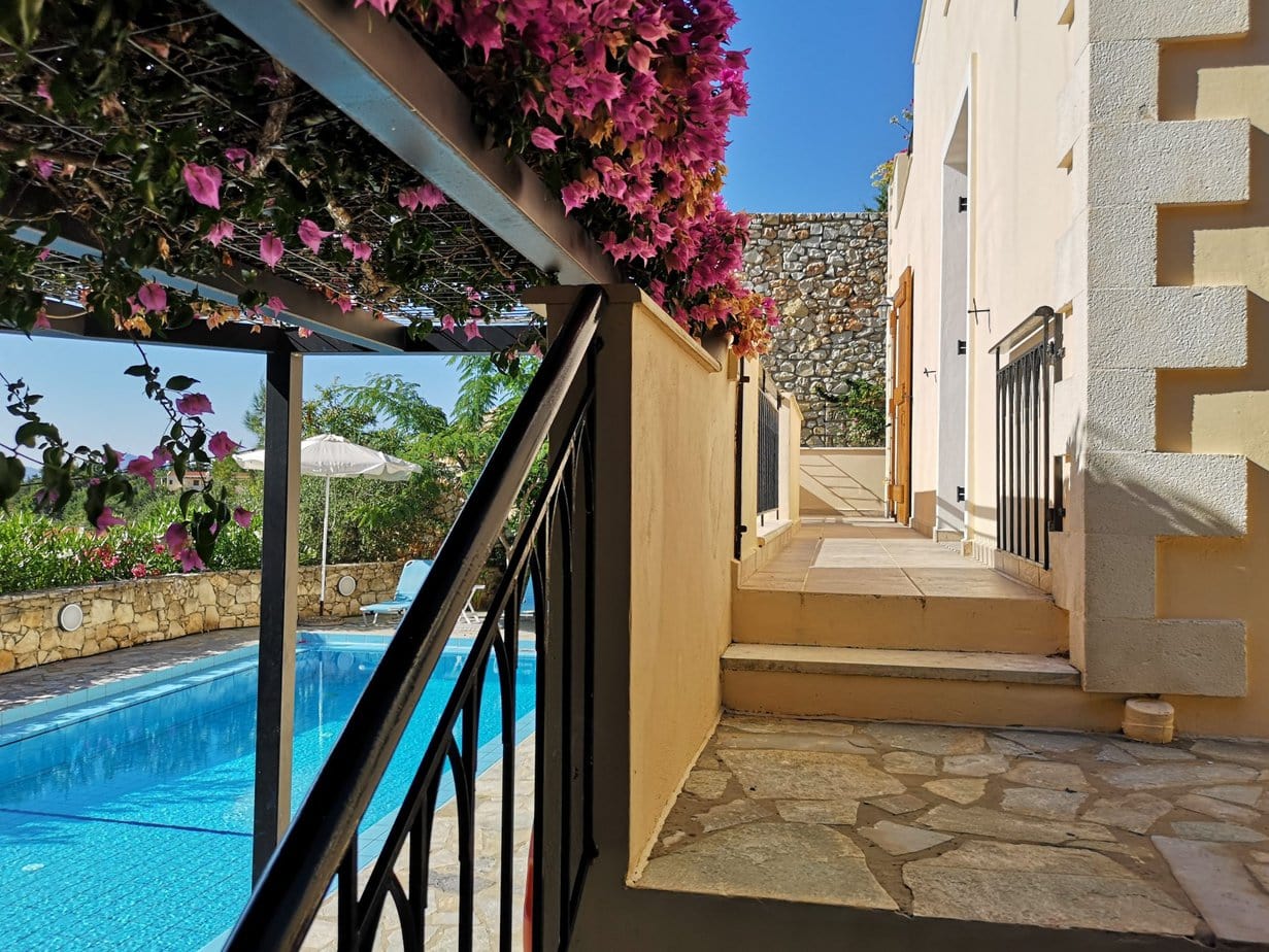 Bedroom terrace leading towards the pool at Villa Koumos