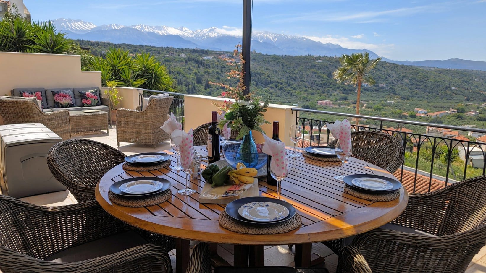 Villa Koumos balcony with table and chairs overlooking the Cretan countryside