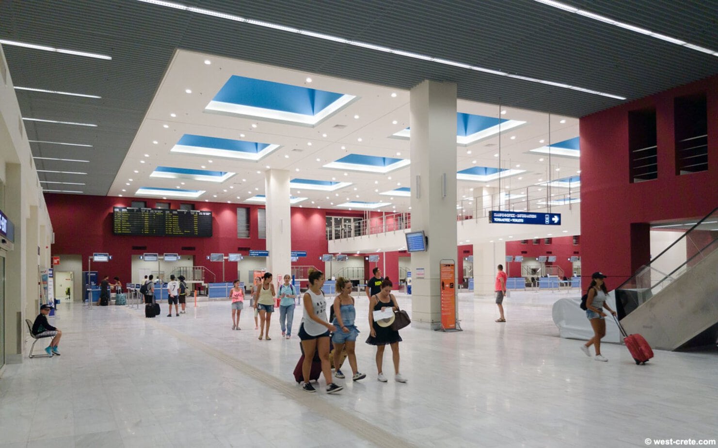 Picture of the departure hall at Chania Airport with people checking in for flights.