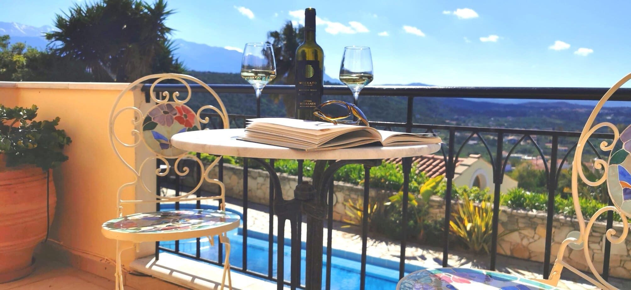 Outdoor table set for drinks with panoramic Crete views at Villa Koumos