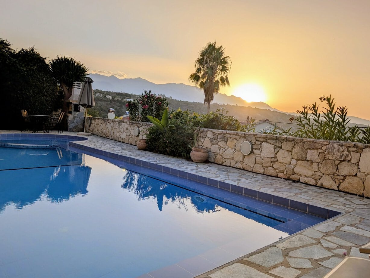 Villa Koumos private heated pool at sunset above Gavalochori, Crete