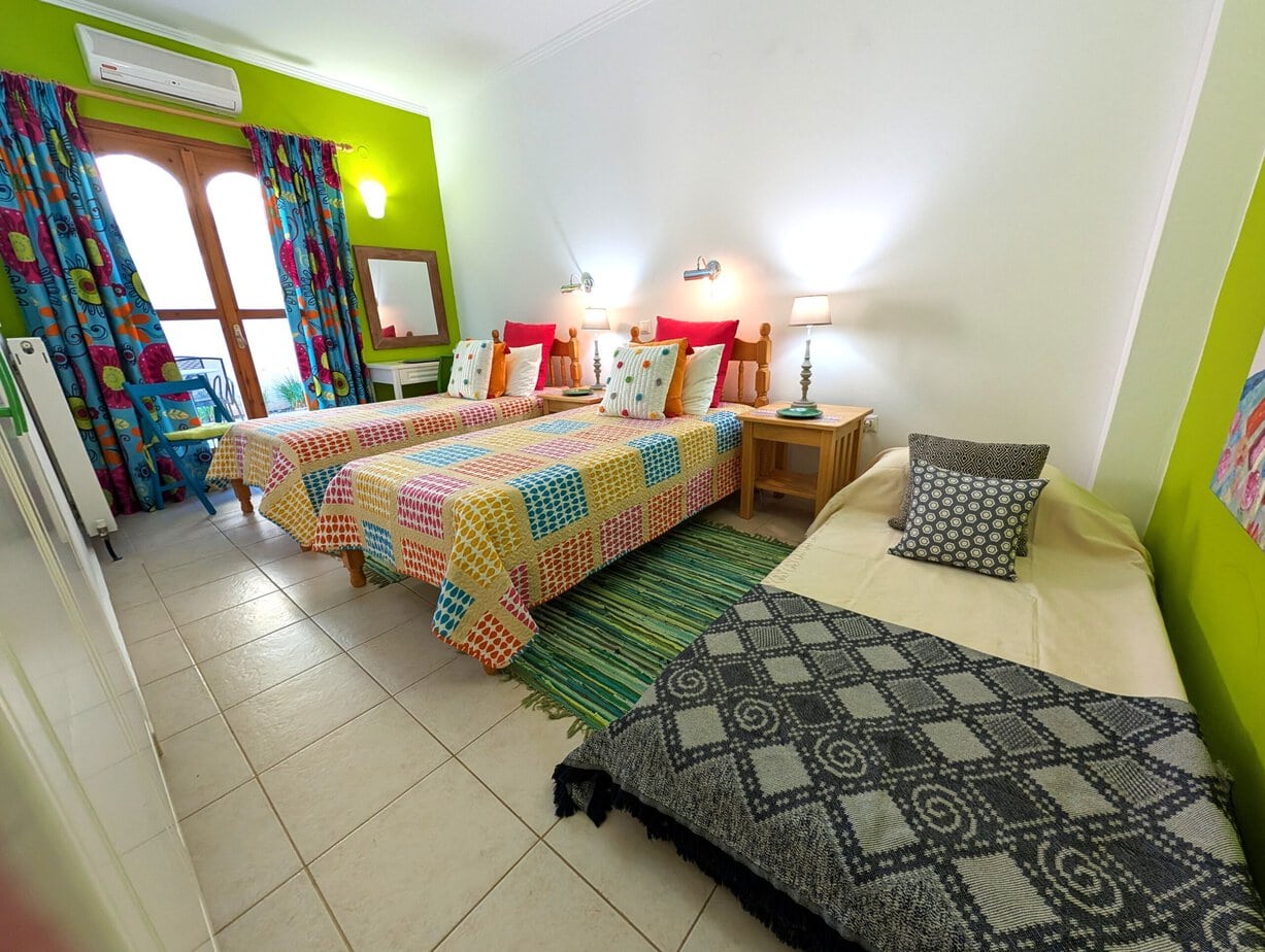 Colourful flexible bedroom that can be arranged with three beds at Villa Koumos